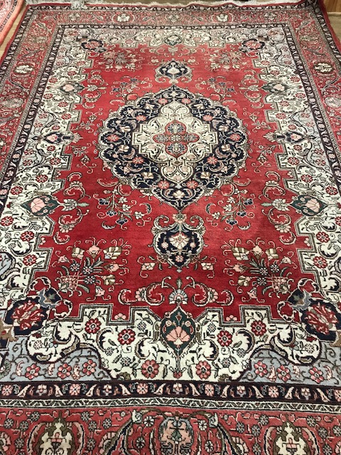 A Persian design red ground carpet 250 x 350cm